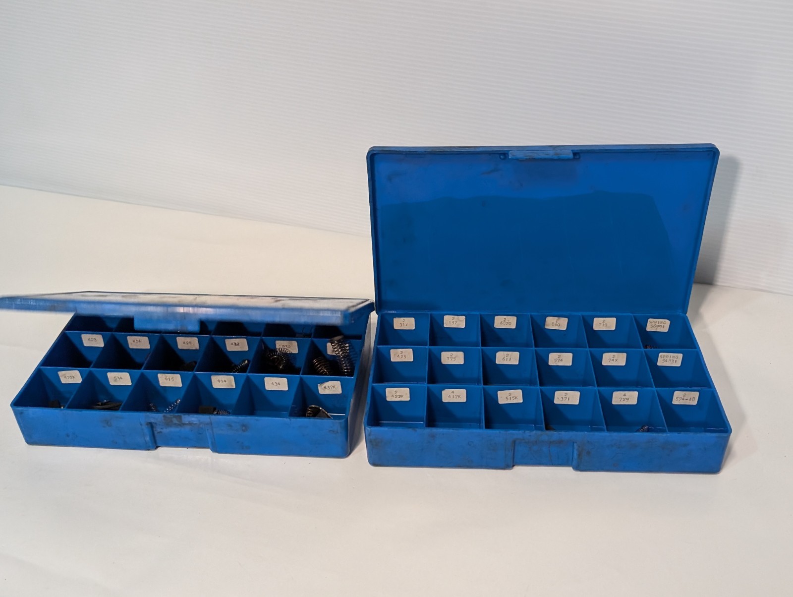 Large lot of assorted motor brushes as shown, two blue organizers included
