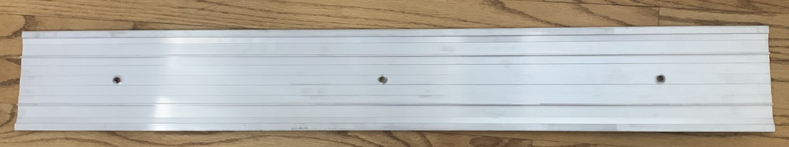 Fluted Saddle 5 in. x 36 in. Aluminum Commercial Threshold, no screws, has scuff