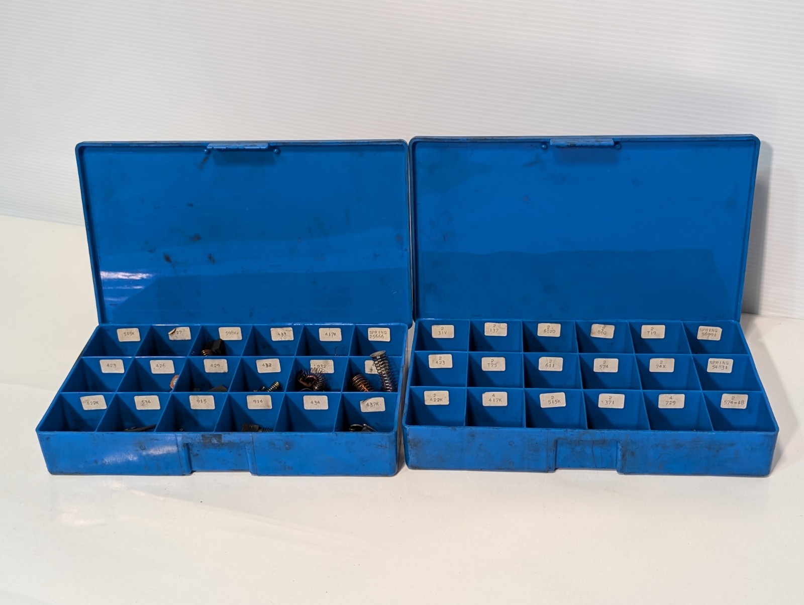 Large lot of assorted motor brushes as shown, two blue organizers included